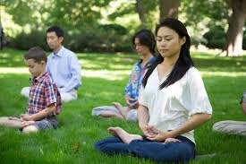 people meditating in park